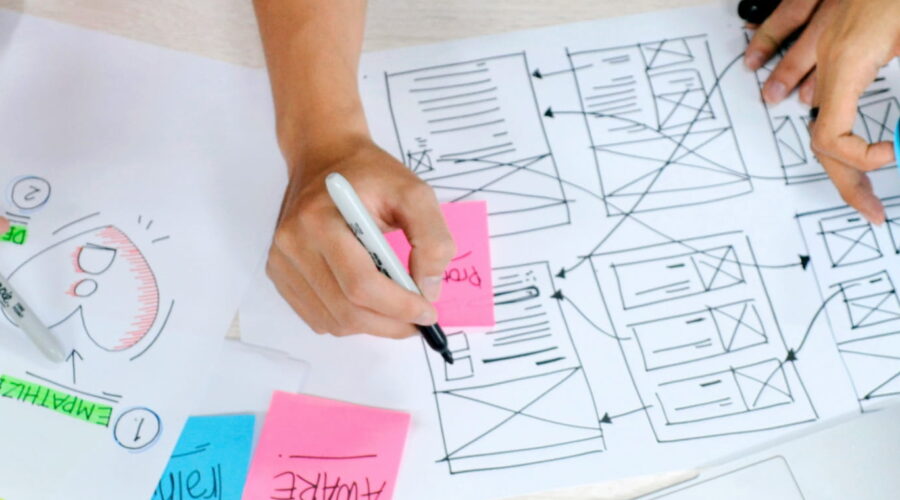 hands scribbling on notes